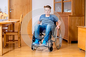 Disabled boy in wheelchair at home