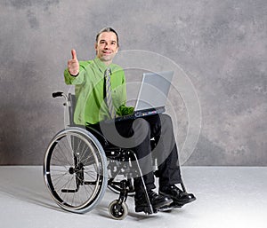 Disabled business man in wheelchair with computer