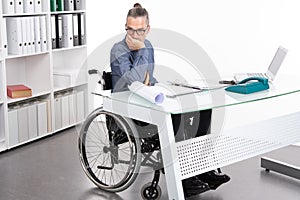 Disabled business man in wheelchair is sorrowful