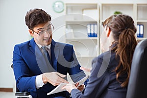 The disabled businessman having discussion with female colleague