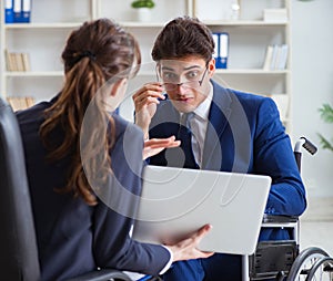 Disabled businessman having discussion with female colleague