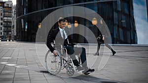 Disabled businessman rolling on wheelchair near businesscentre