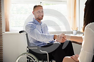 Disabled Businessman Shaking Hand With His Partner