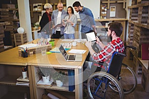 Disabled businessman using digital tablet at desk