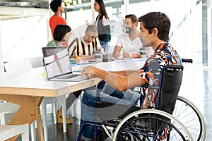 Disabled businessman using laptop in the conference room