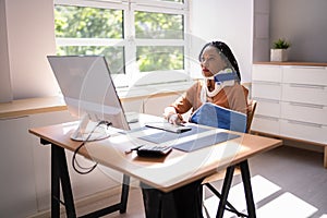 Disabled Businesswoman On Wheelchair Using Computer