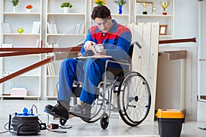 The disabled carpenter working with tools in workshop