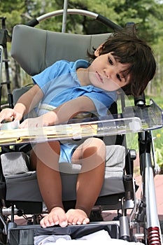 Disabled child in medical stroller