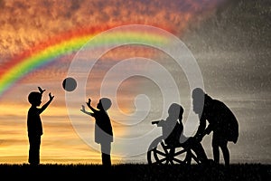 Disabled child in wheelchair crying and his mother near children play with ball