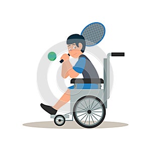 Disabled child in wheelchair. A handicapped young boy sitting in wheelchair while holding racket to playing tennis ball isolated