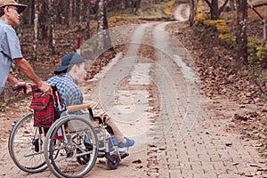 Invalidní na invalidní vozík je studium a cvičení v venkovní jako další lidé rodič les  