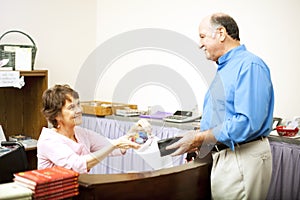 Disabled Clerk Serves Customer