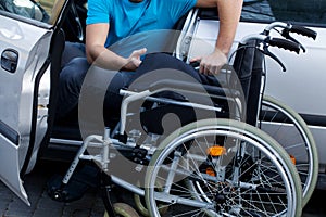 Disabled driver consisting his wheelchair photo