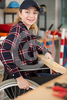 Disabled female carpenter in wheelchair