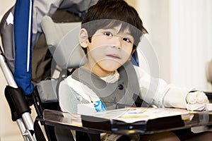 Disabled four year old boy studying