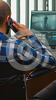 Disabled freelancer videographer talking on phone