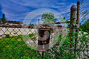 Disabled gate button at Abandoned factory building with broken windows in lake mills WI