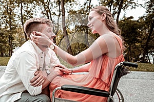 Disabled girl falling in love and touching the hair of boyfriend