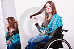 Disabled girl looking at mirror.