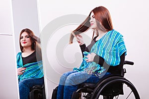 Disabled girl looking at mirror.