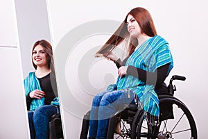 Disabled girl looking at mirror.