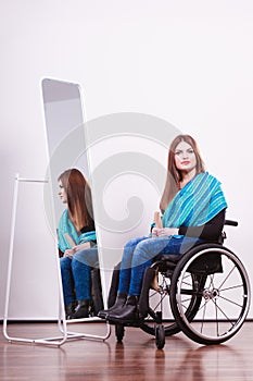 Disabled girl looking at relfection.