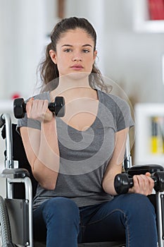 Disabled girl rises dumbbells