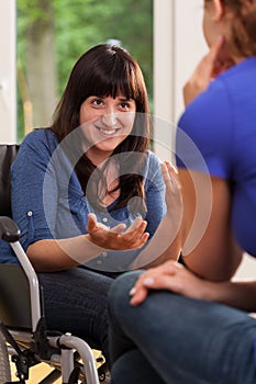 Disabled girl talking with her friend