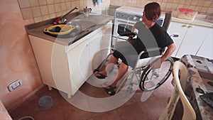 Disabled girl on wheel chair in everyday life in the kitchen