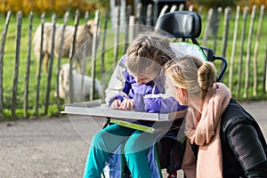 Disabled girl in a wheelchair relaxing outside