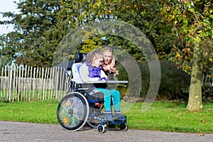 Disabled girl in a wheelchair relaxing outside