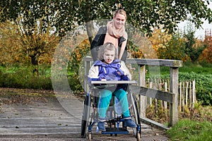 Disabled girl in a wheelchair relaxing outside