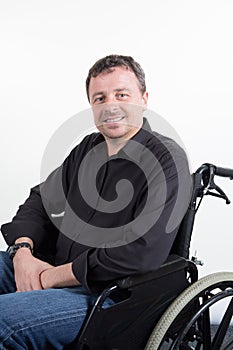 Disabled handsome man in wheelchair paraplegic in white
