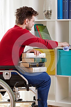 Disabled holding a book and wiped the dust photo