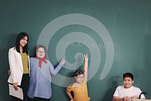 Disabled kids classroom, school boy on wheelchair and down syndrome girls learning and having fun during study at school with