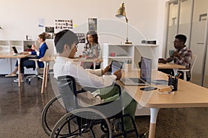 Disabled male executive using digital tablet at desk