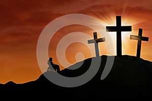 Disabled male repenting at the cross photo