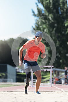 Disabled man athlete jumping with leg prosthesis. Paralympic Sport Concept.