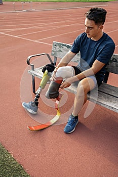 Disabled Man Athlete Sitting in a Bench