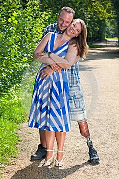 Disabled man and attractive woman in loving hug