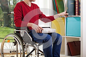 Disabled man clearing out documents