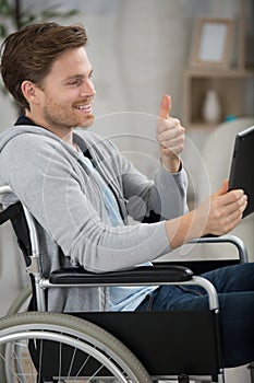 disabled man in communicate via tablet