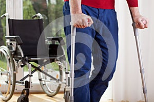 Disabled man on crutches