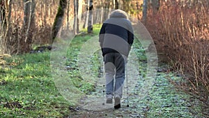 Disabled man on crutches on path