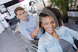 Disabled man dressing hair beautiful young woman