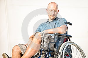 Disabled man with handicap on wheelchair in depression moment