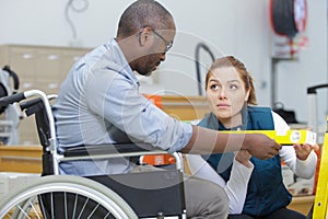 disabled man in hardware store with woman seller