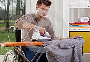 Disabled man during ironing