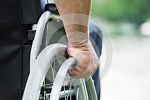 Disabled Man Pushing Wheel Of Wheelchair