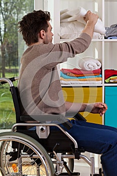 Disabled man reaching out for blanket